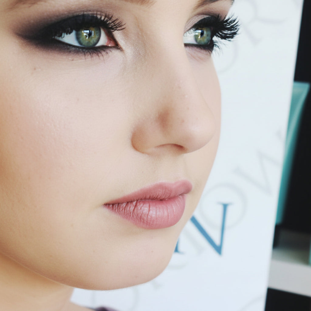 Close-up of a person's face with a magazine in the background